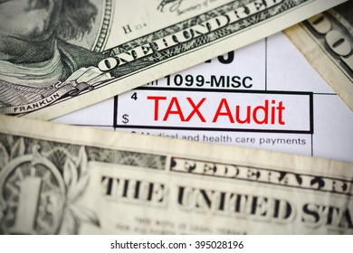US dollar bills on tax form suggesting tax payment or audit - Shutterstock ID 395028196