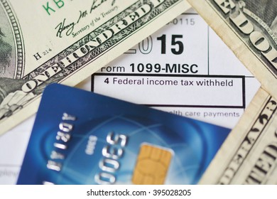 US dollar bills on tax form suggesting tax payment or audit - Shutterstock ID 395028205