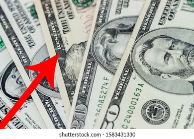 US Dollar Bills And Red Arrow Pointing Upwards Indicating US Economic Growth, Rise In Economy Or Strengthening Of US Dollar