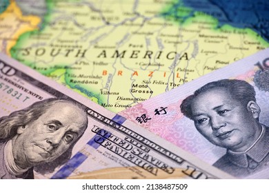 US Dollar And Chinese Yuan On The Map Of Brazil. Economic Competition Between The China And USA In Latin America Countries