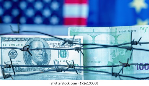 US Dollar And EU Currency Wrapped In Barbed Wire Against United States And European Union Flags As Symbol Of Joint Economic Warfare, Sanctions And Embargo Busting