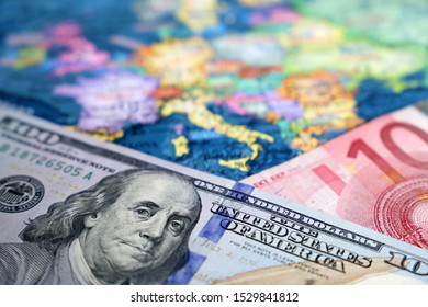 US Dollar And Euro Banknotes On The Map Of Europe. Concept Of Exchange Rate, Investment And Trade Between The United States And European Union