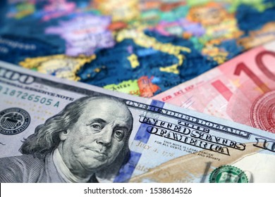 US Dollar And Euro Banknotes On The Map Of Europe. Concept Of Exchange Rate, Investment And Trade Between The United States And European Union	