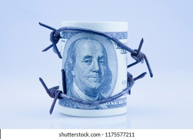 US Dollar Money Wrapped In Barbed Wire As Symbol Of Economic Warfare And Sanctions 