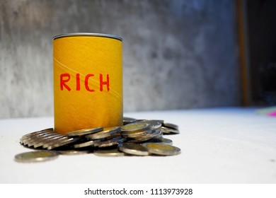 US Dollars And Coins Fill Rich Box With Money.Looking Down On Rich Box  Filled With Coins On A Background .Small Savings Add Up.Coins  On A Rich Box