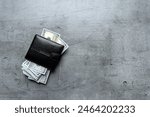 us dollars money in male black wallet on gray background. Lot of one hundred dollar bills