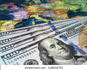 US Dollars On The Europe Map Background. Concept For Trade Between The United States And Europe, American Investment And Domination In EU, Exchange Rate