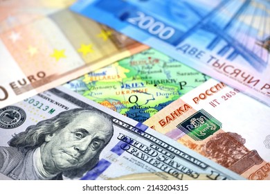 US Dollars, Russian Rubles And Euro Currency On Map Of Ukraine. Concept Of American And European Support For Kiev During Special Military Operation Of Russia