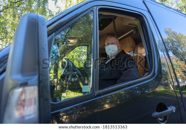 us driver in\
medical mask, leads the bus\
Safe driving during a pandemic,\
protection against\
coronavirus