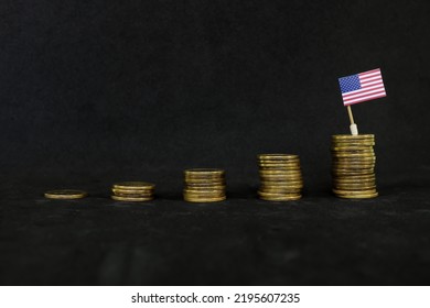 US Economic Growth, Recovery After Financial Crisis And Dollar Appreciation Concept. Flag Of America In Increasing Stack Of Coins In Dark Black Background.