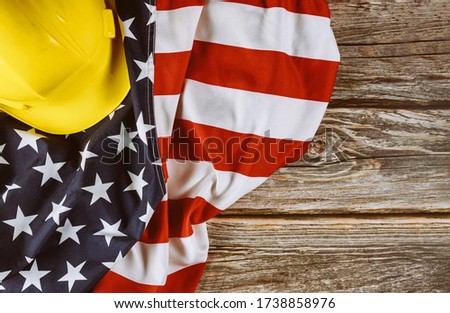 US. federal holiday of Labor Day is United States America of engineer yellow plastic construction helmet, american patriotic background