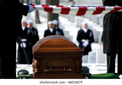 US Flag Being Held Over Casket At Arlington National Cemetery