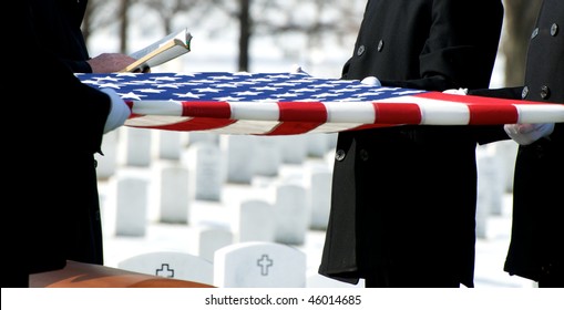 US Flag Being Held Over Casket At Arlington National Cemetery