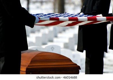 US Flag Being Held Over Casket At Arlington National Cemetery