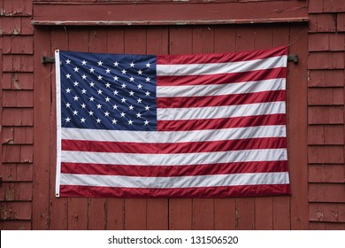 US Flag displayed on red barn door on Memorial Day, 2011, outside of Lexington, MA