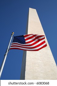 US Flag In Front Of Washington Monument With Blue Sky