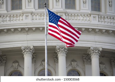 US flag on Capitol Building Dome Background, Washington, DC, USA.