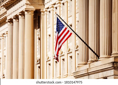 US Flag Over Classical Government Building With Columns In Washington, DC