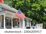 US flag proudly displayed in front of an American house symbolizes patriotism, national identity, and love for one