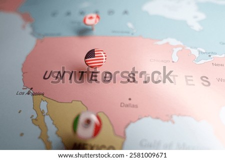  US flag push pin marking the United States on a map, with Mexico and Canada location pins visible. High quality photo