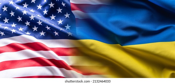 US flag together with Ukrainian flag in a single picture, flags blending one into the other. - Shutterstock ID 2132464033