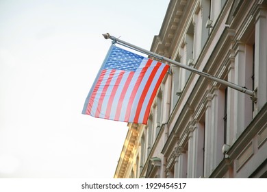 Us flags on the wall of an old stone building