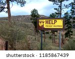 US Forest Service sign with Smokey Bear in the Rocky Mountains of Colorado. Burned out trees from the 2002 Hayman Fire 16 years later in the Pike National Forest of Colorado.