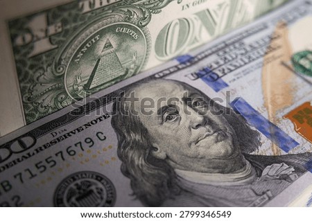 US hundred dollar bills stack with one dollar bill background