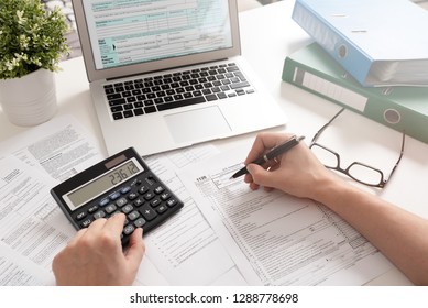 US Individual income tax return. Accountant working with US tax forms - Shutterstock ID 1288778698
