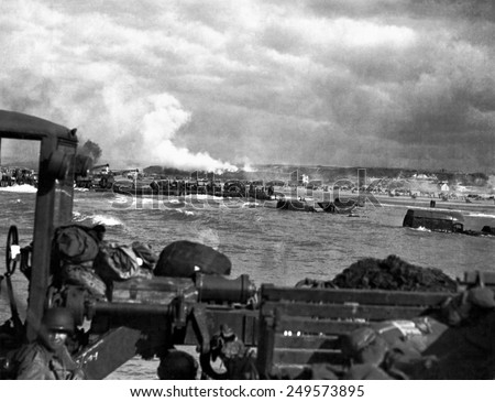 U.S. landing craft approaching Omaha Beach in Normandy beach on Dec. 6, 1944. Soldiers are standing on ships decks, indicating heavy German resistance had ceased. France, World War 2.
