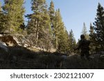 U.S. Marines with Alpha Company, 1st Battalion, 6th Marine Division, 2nd Marine Division (MARDIV), patrol through mountainous terrain to get into position to execute a rock cliff assault at landing zo