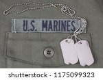 U.S. MARINES Tape with dog tags on olive green uniform background