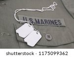 U.S. MARINES Tape with dog tags on olive green uniform background