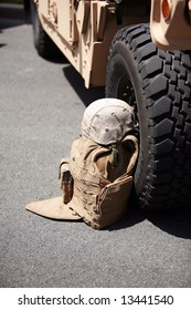 Us Military Flack Jacket And Helmet Lay Against A H1 Humvee