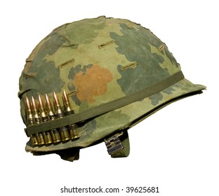 A US military helmet with an M1 Mitchell pattern camouflage cover from the Vietnam war, and six rounds of 7.62mm ammunition.