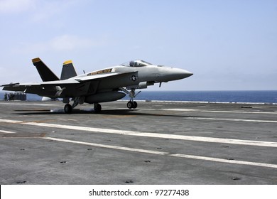 U.s Navy F18 Fighter Jet Landing On An Aircraft Carrier