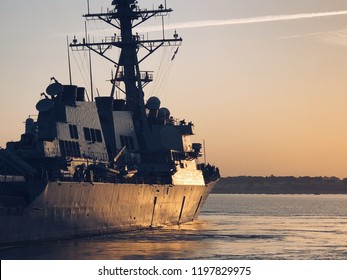 A US Navy Frigate Sailing In A Naval Base 