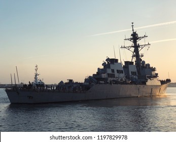 A US Navy Frigate Sailing In A Naval Base 