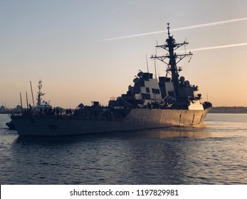 A US Navy Frigate Sailing In A Naval Base 