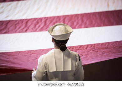 U.S. Navy Military Service Member Holds A Large American Flag During The Memorial Day Observance Ceremony On The Intrepid Sea, Air & Space Museum, Fleet Week, NEW YORK MAY 29 2017.