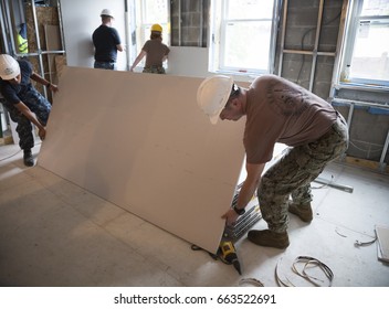 US Navy Seabees And Sailors Based In Norfolk, VA Help Habitat For Humanity NYC On A Home Building Project In The Brownsville Section Of Brooklyn During Fleet Week New York, NEW YORK MAY 25 2017.