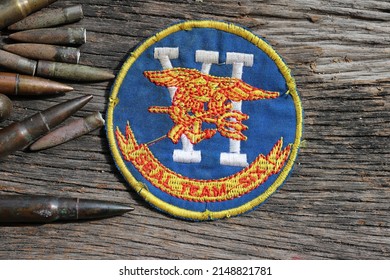 US NAVY SEAL TEAM SIX, Military Patch US Army Military Ammunition Bulet On Wood Background - Image