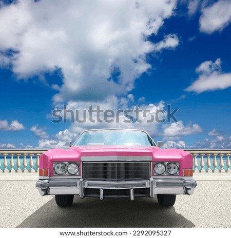 US old timer cabrio in pink, by the sea.