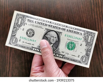 US One Dollar Bill In Hand.  