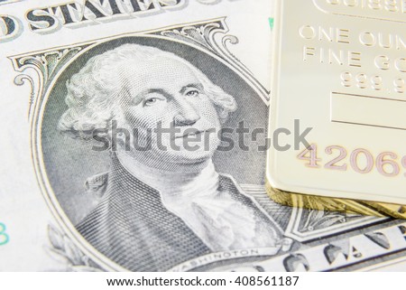 US one dollar bill with image / portrait of George Washington and gold bullion. A concept of the two most popular currency reserve in all countries in the world.