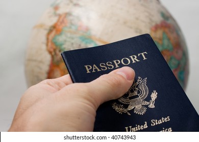 US Passport Holder Handing Passport Over, Globe In The Background