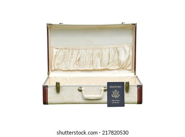 US Passport Leaning On Opened Empty Vintage Suitcase Isolated On White Background