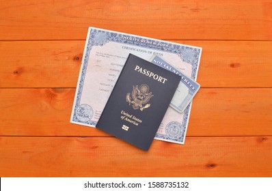 US Passport, Social Security Card And Birth Certificate On Wood Table