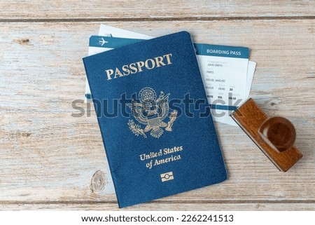 US passport and stamp on wooden background. Safe journey with necessary documentation. Top view. Copy space. Your Key to International Travel