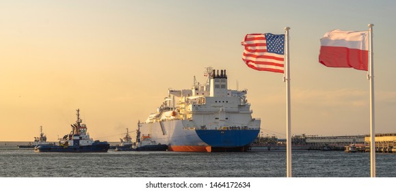 The US and Polish Flags and the American LNG tanker during the supply of liquefied gas to the LNG terminal in Świnoujście in Poland as part of a multi-annual agreement between the USA and Poland